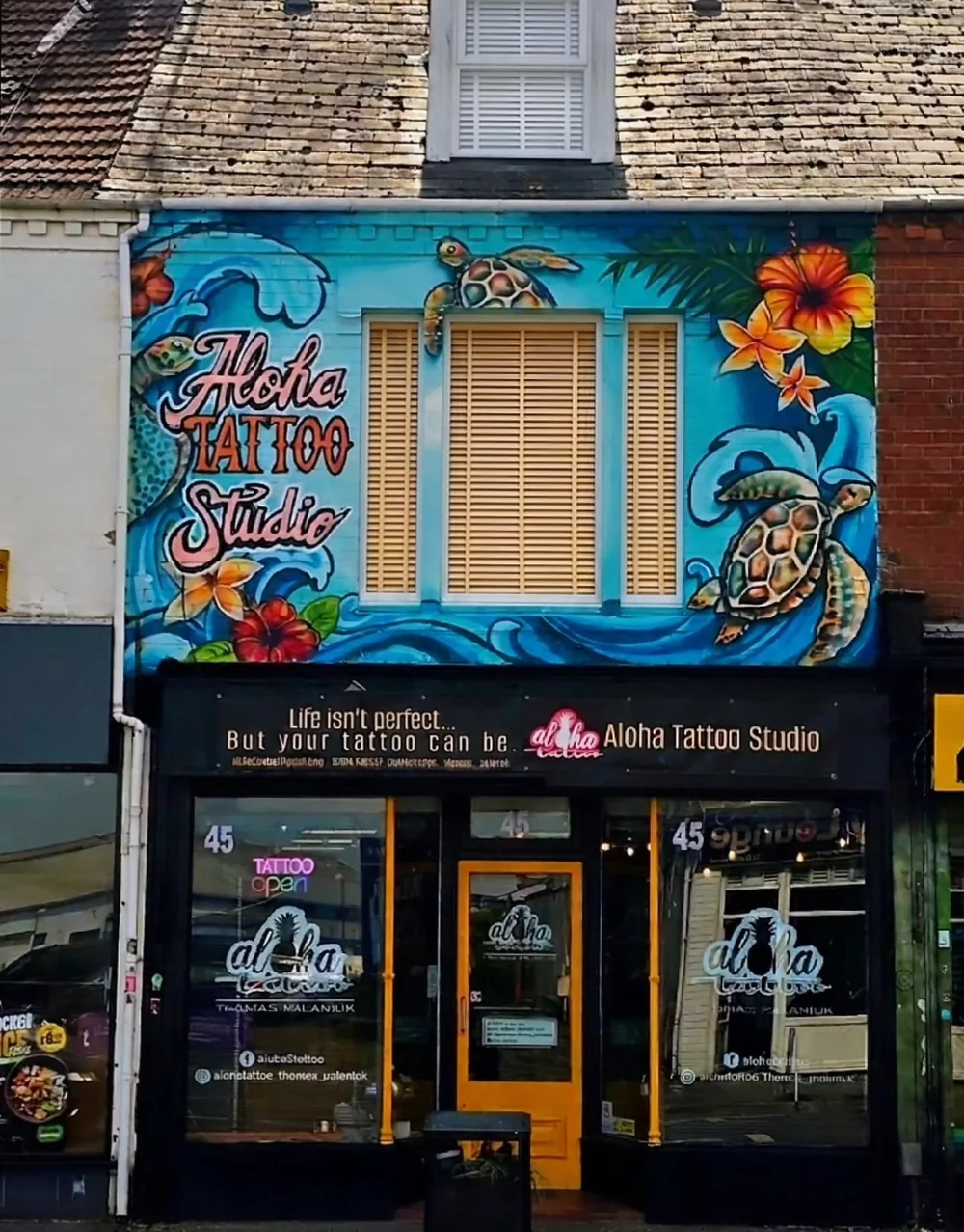 Hand-painted tattoo studio shopfront in Gloucester by Thomas Palaniuk
